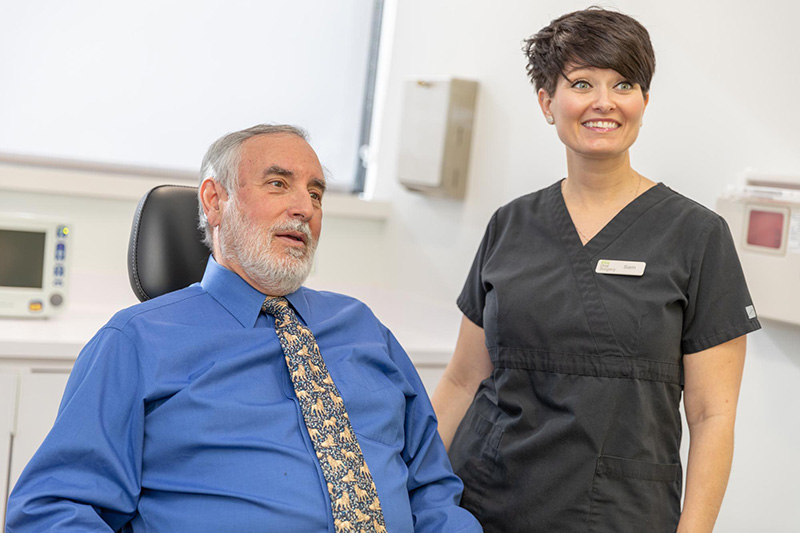 Patient smiling after dental implants treatment